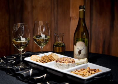Keep it simple! Cheese, crackers, and roasted mixed nuts are all it takes to set off the buttery flavors in Cache Creek Vineyards Chardonnay
